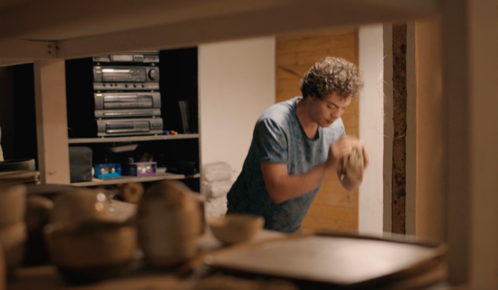 Artist working with clay in the studio.