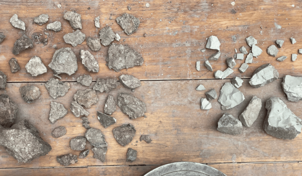 Minerals and rocks arranged on a wooden worktable.